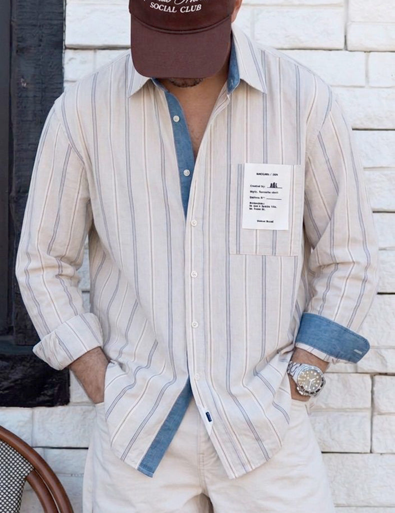 Camisa de rayas unisex  de estilo oversize y tejido de algodón premium, corte relajado con bolsillo frontal y etiqueta con número de serie para que sea única. Estampado en la espalda con mensaje, estilo minimalista y urbano