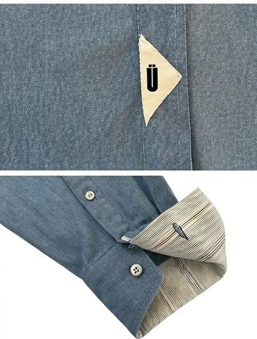 Camisa unisex de estilo  oversize con tejido algodón efecto denim y contraste en interior cuello y puños con un tejido de rayas, fit relajado estilo minimalista y moderno y urbano. estampado en la espalda y en el bolsillo delantero una etiqueta con número de serie exclusivo y personalizado